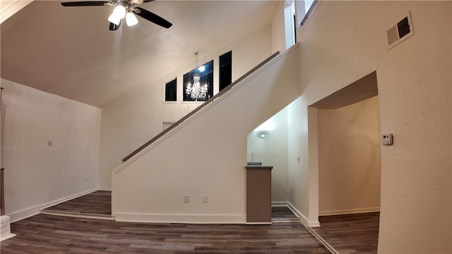 unfurnished living room with ceiling fan, dark hardwood / wood-style flooring, and vaulted ceiling