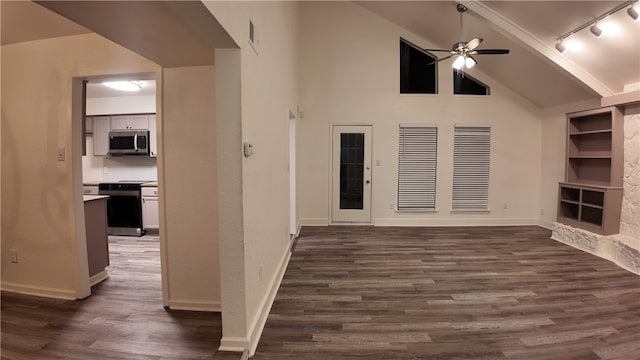 unfurnished living room with dark hardwood / wood-style flooring, rail lighting, high vaulted ceiling, and ceiling fan