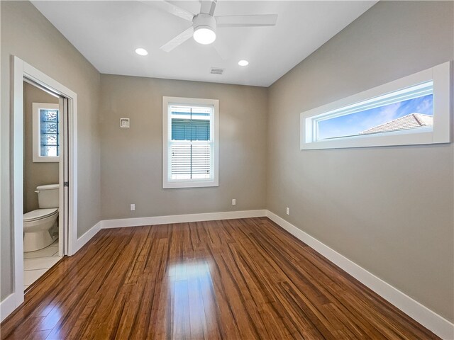 unfurnished room with dark hardwood / wood-style floors and ceiling fan