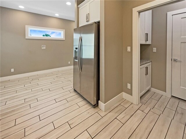 bathroom with a shower with door, tile patterned flooring, and toilet