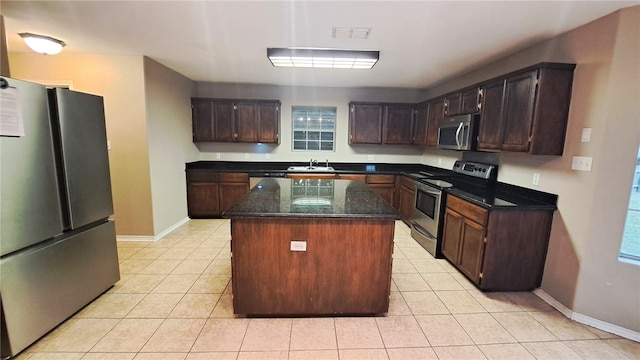 2906 Alice Ln, Kingsville, TX 78363 - kitchen featuring light tile patterned floors, baseboards, a sink, and appliances with stainless steel finishes