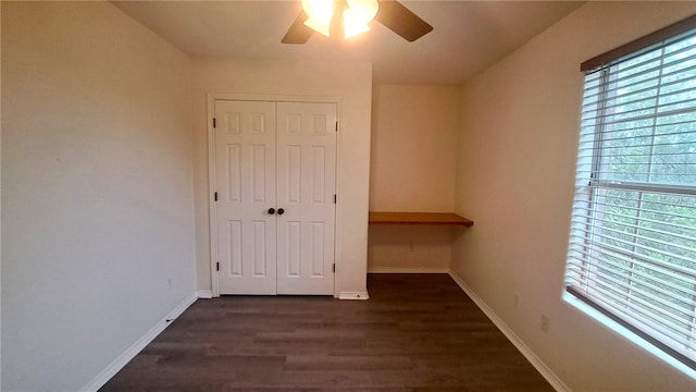 2906 Alice Ln, Kingsville, TX 78363 - unfurnished bedroom featuring baseboards, a closet, ceiling fan, and dark wood-style flooring