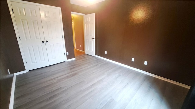 2906 Alice Ln, Kingsville, TX 78363 - unfurnished bedroom featuring baseboards, wood finished floors, and a closet