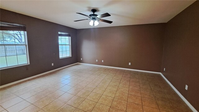 2906 Alice Ln, Kingsville, TX 78363 - empty room featuring baseboards, a ceiling fan, and light tile patterned floors