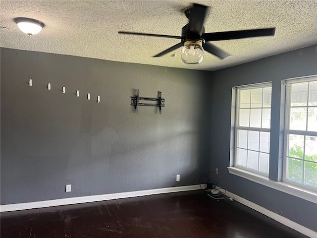 spare room featuring a textured ceiling, hardwood / wood-style flooring, and ceiling fan