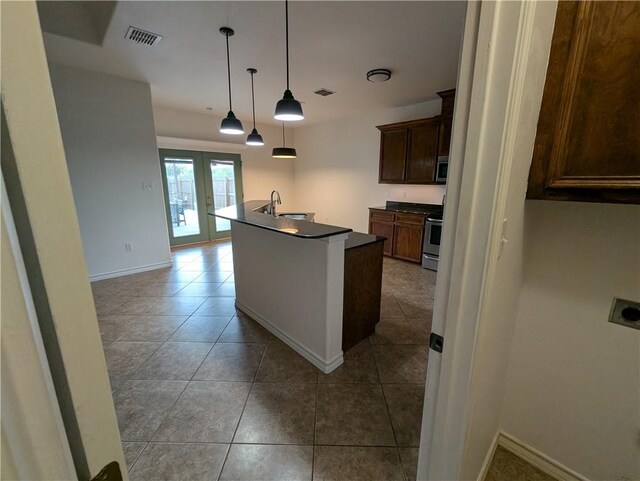 2905 Dante Dr, Corpus Christi, TX 78415 - kitchen with appliances with stainless steel finishes, french doors, dark countertops, and tile patterned floors