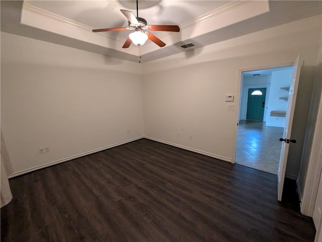 2905 Dante Dr, Corpus Christi, TX 78415 - empty room featuring a raised ceiling, ornamental molding, dark wood-style floors, and ceiling fan