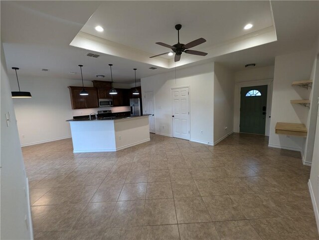 2905 Dante Dr, Corpus Christi, TX 78415 - kitchen with stainless steel appliances, a tray ceiling, dark countertops, open floor plan, and recessed lighting