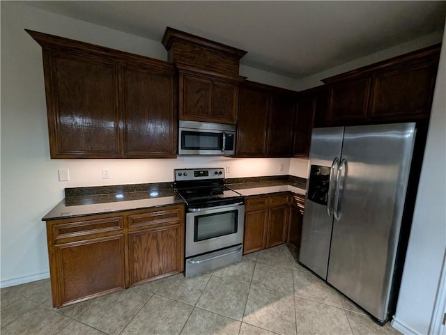 2905 Dante Dr, Corpus Christi, TX 78415 - kitchen with appliances with stainless steel finishes, dark countertops, light tile patterned flooring, and dark brown cabinetry