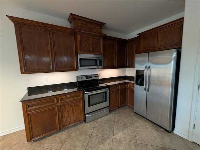 2905 Dante Dr, Corpus Christi, TX 78415 - kitchen with stainless steel appliances, light tile patterned flooring, and dark brown cabinets