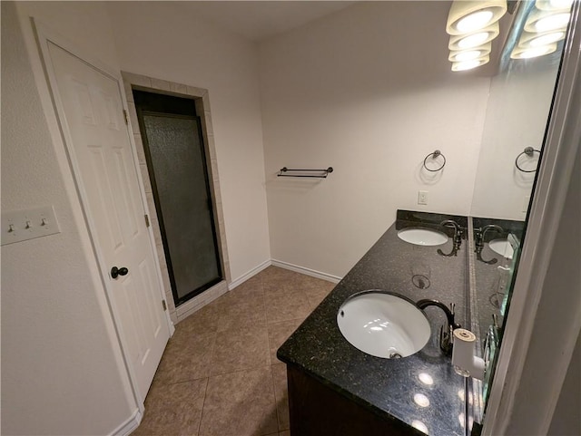 2905 Dante Dr, Corpus Christi, TX 78415 - bathroom with double vanity, tile patterned flooring, and a stall shower