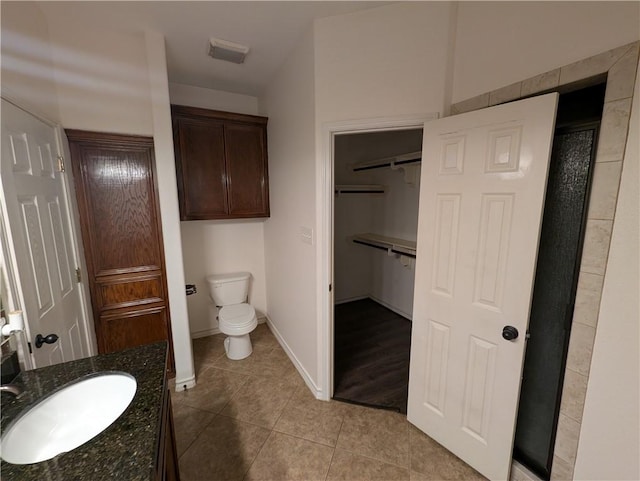 2905 Dante Dr, Corpus Christi, TX 78415 - bathroom featuring tile patterned flooring, vanity, and a closet
