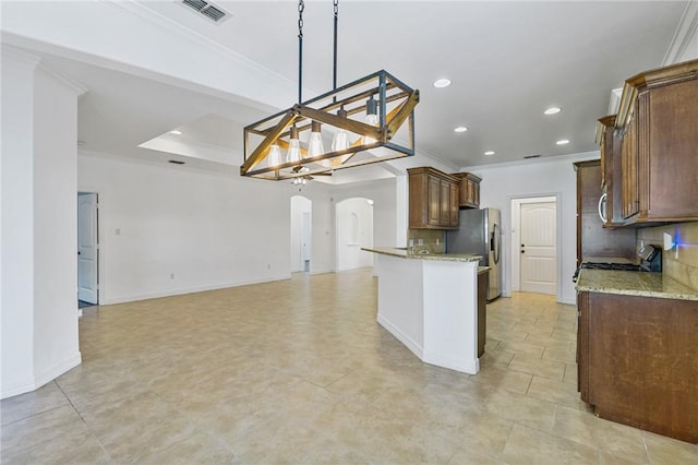 2633 Date Palm Dr, Corpus Christi, TX 78418 - kitchen with arched walkways, crown molding, backsplash, open floor plan, and recessed lighting