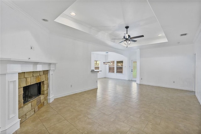 2633 Date Palm Dr, Corpus Christi, TX 78418 - unfurnished living room with ceiling fan, a raised ceiling, a fireplace, crown molding, and baseboards