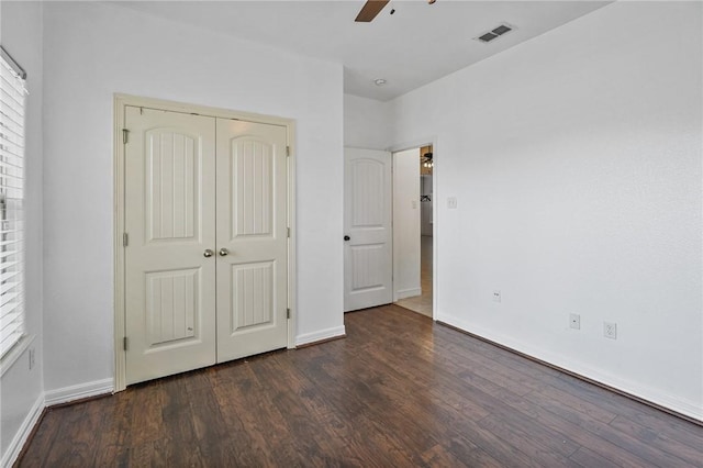 2633 Date Palm Dr, Corpus Christi, TX 78418 - unfurnished bedroom with dark wood-style flooring, baseboards, and a closet