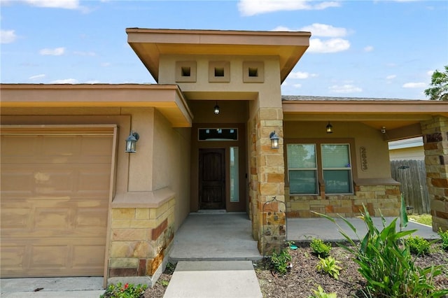 2633 Date Palm Dr, Corpus Christi, TX 78418 - property entrance featuring an attached garage, stone siding, and stucco siding