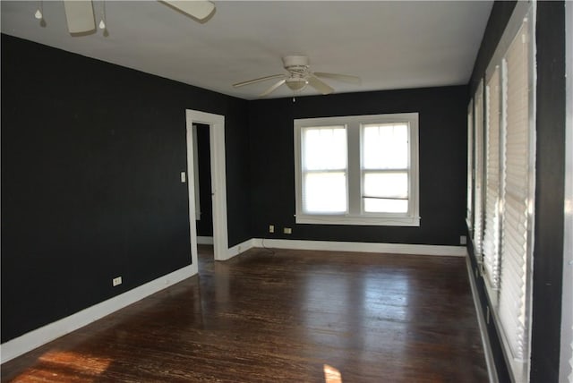 empty room with dark hardwood / wood-style floors and ceiling fan