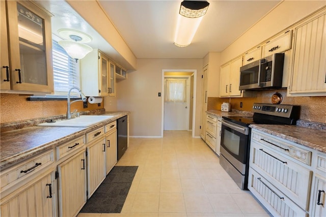 3814 Whitney Dr, Corpus Christi, TX 78410 - kitchen with appliances with stainless steel finishes, decorative backsplash, glass insert cabinets, and light tile patterned flooring