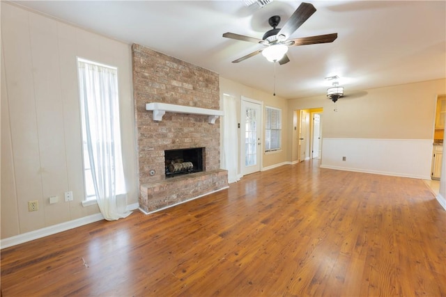 3814 Whitney Dr, Corpus Christi, TX 78410 - unfurnished living room featuring ceiling fan, wood finished floors, and a large fireplace