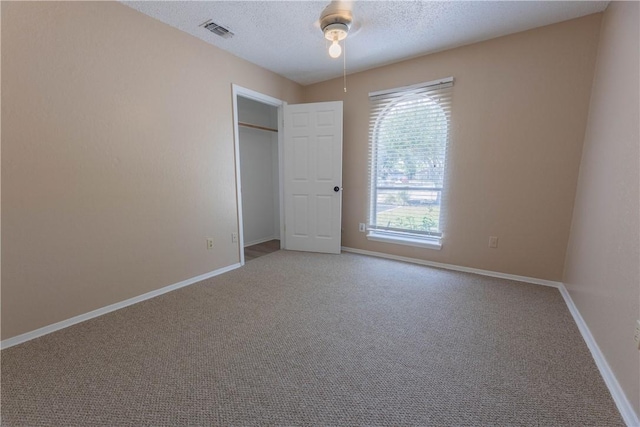 3814 Whitney Dr, Corpus Christi, TX 78410 - unfurnished bedroom featuring light colored carpet, a textured ceiling, ceiling fan, and a closet