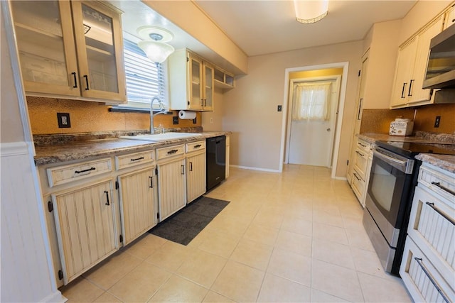 3814 Whitney Dr, Corpus Christi, TX 78410 - kitchen featuring appliances with stainless steel finishes, decorative backsplash, glass insert cabinets, and light tile patterned floors