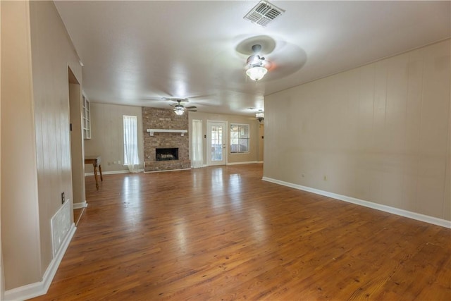 3814 Whitney Dr, Corpus Christi, TX 78410 - unfurnished living room with ceiling fan, wood finished floors, and a large fireplace