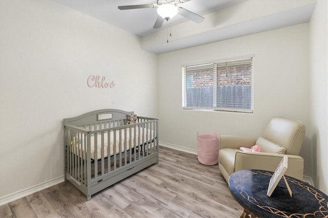 8129 Resplandor St, Corpus Christi, TX 78414 - bedroom featuring wood finished floors, baseboards, a ceiling fan, and a nursery area