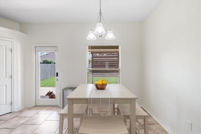 8129 Resplandor St, Corpus Christi, TX 78414 - dining area featuring a chandelier, light tile patterned floors, and baseboards