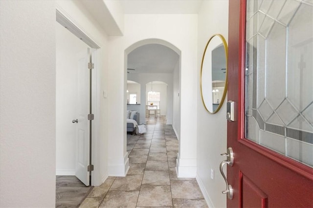 8129 Resplandor St, Corpus Christi, TX 78414 - entryway featuring arched walkways, baseboards, and light tile patterned flooring