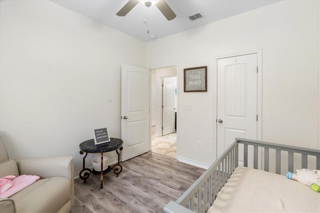 8129 Resplandor St, Corpus Christi, TX 78414 - bedroom with wood finished floors, baseboards, ceiling fan, and a nursery area