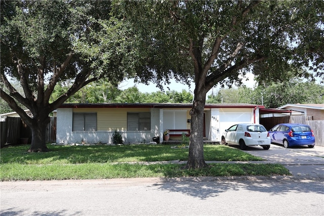 ranch-style home featuring a garage and a front yard