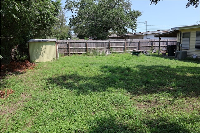 view of yard with a storage unit and central AC unit