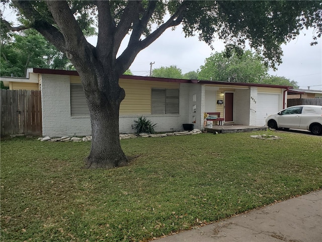 view of front of home featuring a garage and a front lawn