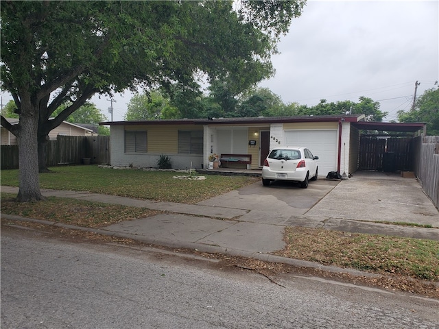 single story home with a garage and a front yard