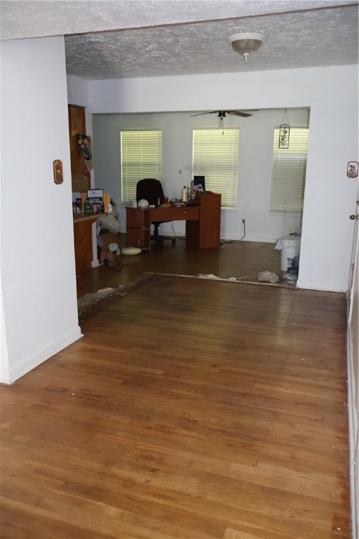 interior space featuring a textured ceiling and hardwood / wood-style flooring