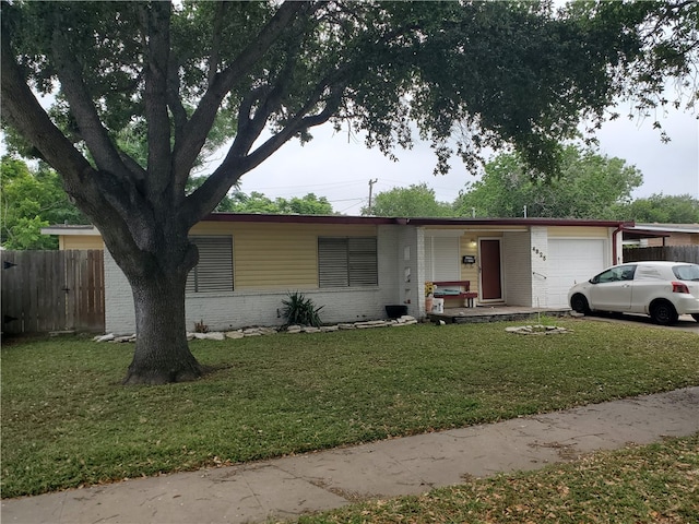 ranch-style home with a garage and a front yard