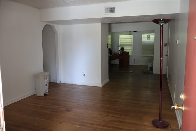 empty room with dark wood-type flooring