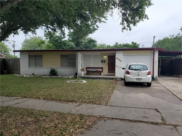 single story home with a garage, a porch, and a front lawn