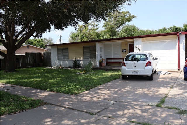 single story home with a garage and a front yard