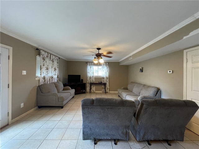 tiled living room with ornamental molding and ceiling fan