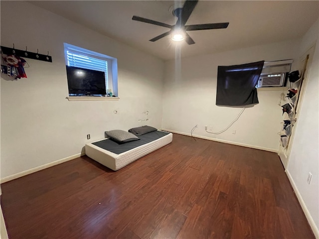 unfurnished living room featuring a wall mounted AC, dark wood-type flooring, and ceiling fan