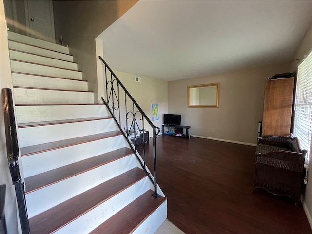 stairs with hardwood / wood-style floors