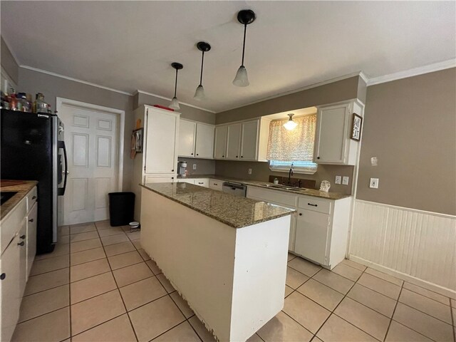 kitchen featuring a center island, sink, crown molding, white cabinetry, and decorative light fixtures