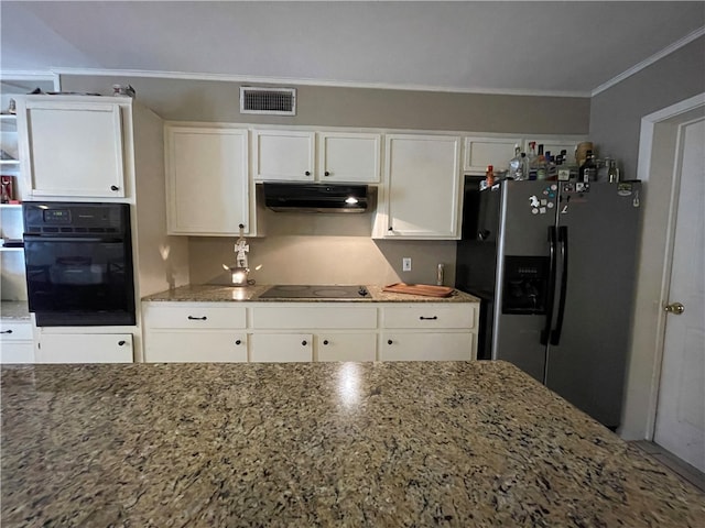 kitchen featuring white cabinets, dark stone counters, and black appliances