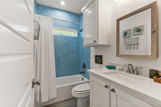 full bathroom featuring vanity, toilet, hardwood / wood-style floors, and shower / bath combo