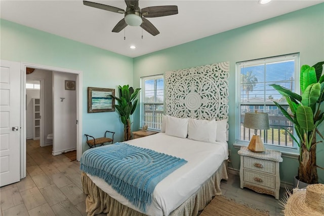 bedroom with light hardwood / wood-style flooring and ceiling fan