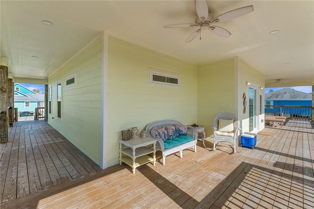 wooden deck featuring ceiling fan