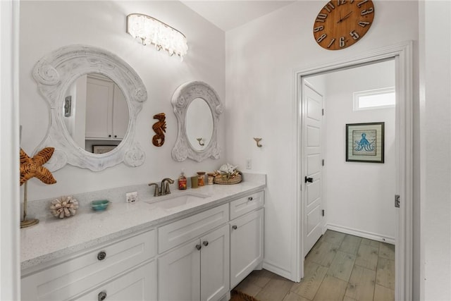 bathroom with hardwood / wood-style flooring and vanity