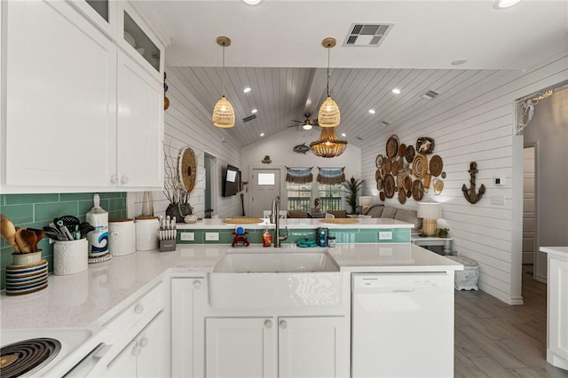 kitchen with white cabinetry, dishwasher, and kitchen peninsula