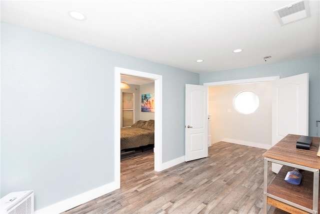 unfurnished office featuring recessed lighting, baseboards, visible vents, and light wood finished floors